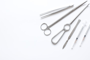 instruments for plastic surgery on white background top view