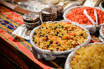 Colorful variety dry fruits and nuts in the street shop vibrant background