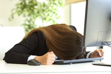 Businesswoman banging the head against the table