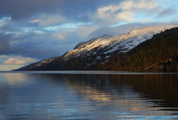Fototapeta premium Evening winter scenery by Loch Ness, snowy highlands