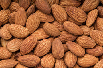 Fototapeta premium Peeled almonds close up, top view