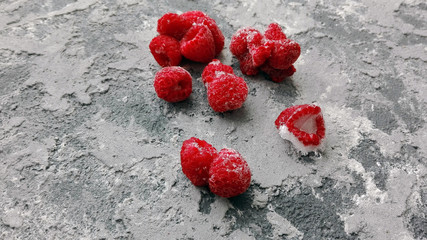 frozen raspberries on cold concrete surface