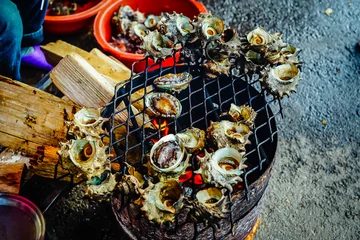 Garden poster Sea Food Grilled turban shells in seafood shop near Seopjikoji, Jeju isla
