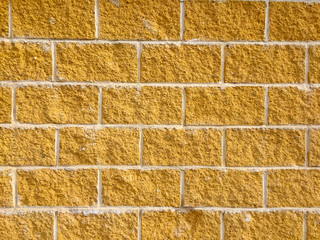 Texture of a wall with yellow bricks