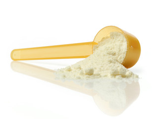 powdered milk in plastic spoon