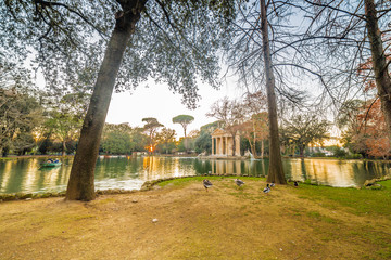 lake with roman building in park