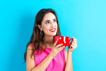 Happy young woman drinking coffee