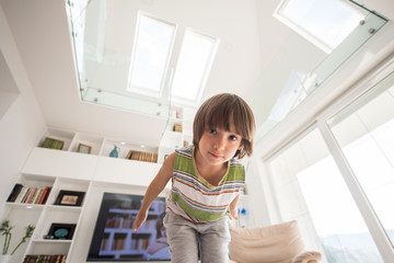 Happy cute little boy at new modern home