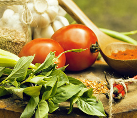 vegetables on wooden kitchen with spicies, tomato, chilli, green