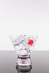 Sparkling beverage in a martini glass with a cherry