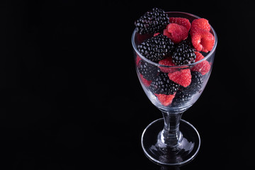 Blackberries and raspberries in a glass