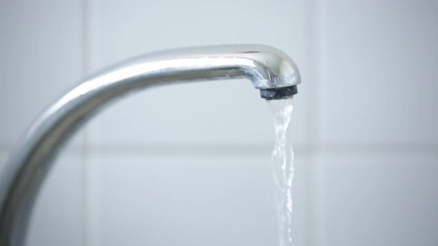 water running from a tap: water wastage 