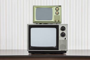 Vintage Televisions Stacked on Table