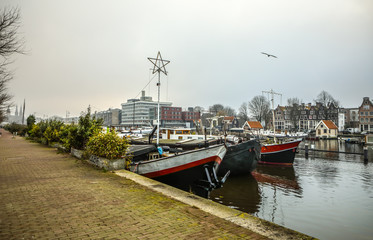AMSTERDAM, NETHERLANDS - JANUARY 02, 2017: Boats on water in cloudy weather. January 02, 2017 in Amsterdam - Netherland.