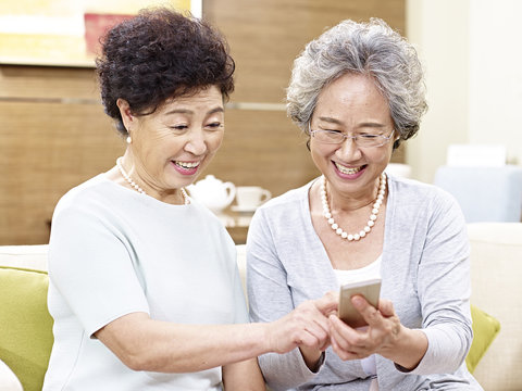 senior asian women using mobile phone