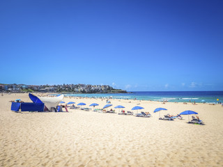 People sunbathing on the Bondi Beach in Bright Sunny Day, Australia