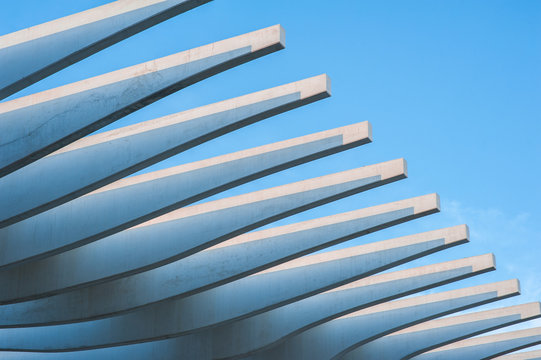 Modern stone promenade roof architecture by the shoreline of Palmeral de las sorpresas port in Malaga, Andalusia, Spain, Blue sky at sunset.