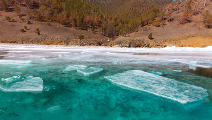 Growers ice iceberg in turquoise water of Lake Baikal