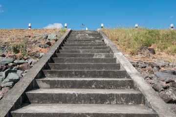 Dam up the cement stairs with blue sky
