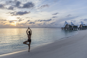 Woman exercise with Yoga on the beach