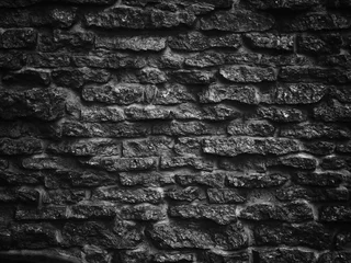 Wall murals Stones black stone wall background or texture