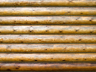 Natural wooden background from parallel wooden logs