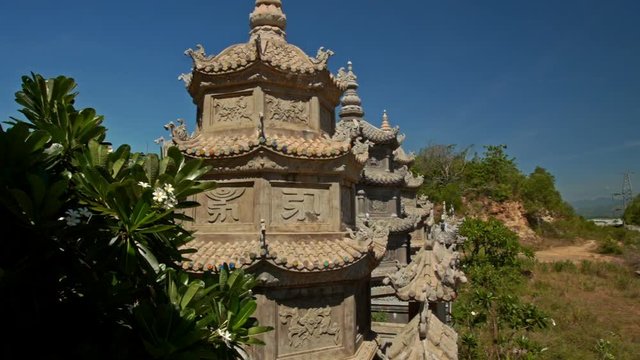 Wall with Small Stone Pagodas by Buddhist Temple Blue Sky