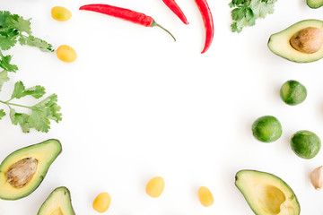 Frame made of raw food: avocado, chili pepper, coriander, cherry tomato, lime, garlic. Flat lay, top view. Food concept.