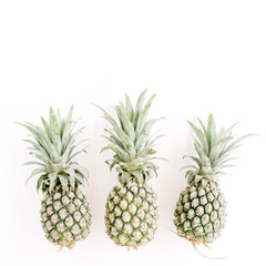 Pineapples on white background. Flat lay, top view. Creative food concept