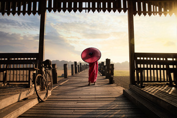 Monk walk on the wooded bridge, U Bein Bridge, Mandalay Myanmar