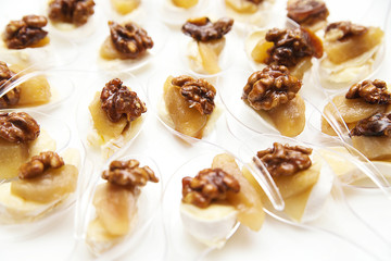 appetizer with cheese and walnuts for buffet on white background