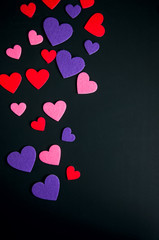 Colored hearts over black background.