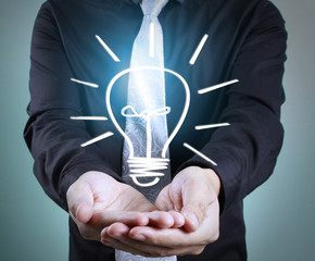 Hands of  holding light bulb