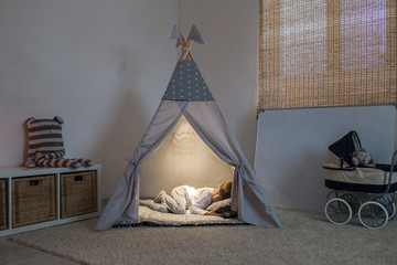 boy sleeps in the teepee