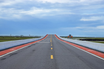 Fototapeta premium Empty road and the yellow traffic lines