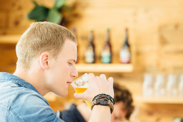 Handsome man drinking light beer