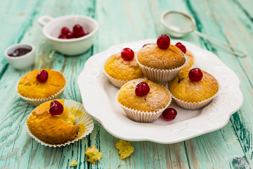 Delicious homemade pastries. Muffins with cherries on wooden table.