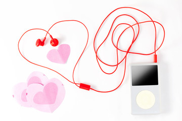 music player with red earphone and paper note on white backgroun