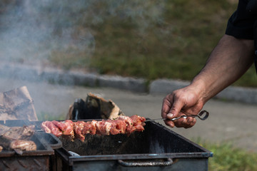 barbeque grill, skewers with meat, brazier, cauldron, chef controls willingness dishes