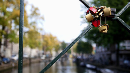 Amsterdam canal, Holland, Netherlands - view from bridge, wedding locks