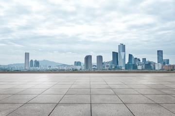 Obraz premium modern buildings in seoul from brick floor in cloud sky