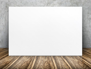 Blank long white paper poster leaning at concrete wall on wooden