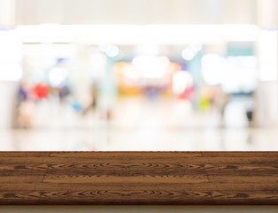 Wood table top with shopping store bokeh light background,Mock u