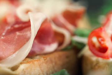 Bruschetta with prosciutto close up. Italian snack for wine