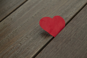 Red paper heart on wood background,  love concept