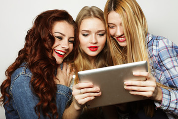 hipster girls friends taking selfie with digital tablet