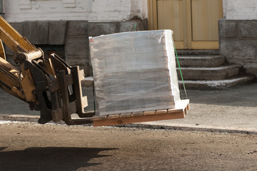 forklift transports the pallet with the load