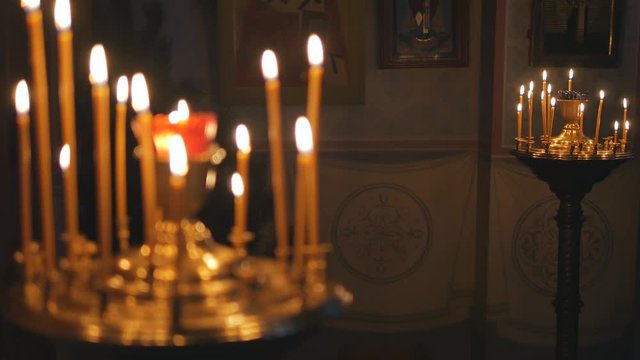 Burning candles in an Orthodox Church. Icons and prayer.
