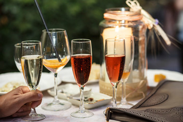 Glasses with champagne, wine and water stand on round table