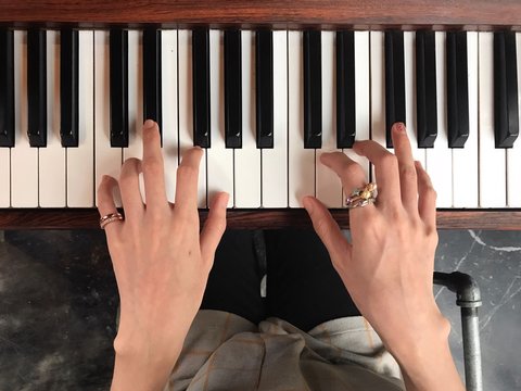 woman hands and fingers playing piano